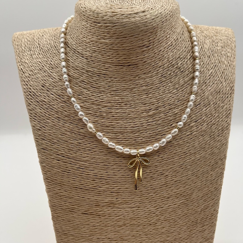 Elegant Pearl Necklace with Gold Bow Pendant